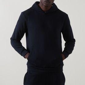 Model wearing Arne navy hoodie with kangaroo pocket, styled with matching navy joggers