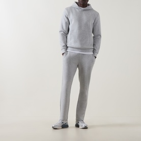 Model wearing Arne Essential Slim-Leg Sweatpants in Marl Grey, styled with matching grey hoodie and grey trainers.