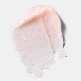 Clinique exfoliator texture swatch showing a pale pink creamy scrub with a powdery, granular consistency on a white background