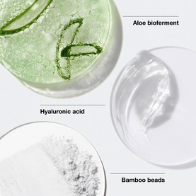 Clinique exfoliator key ingredients: aloe bioferment, hyaluronic acid, and bamboo beads displayed in glass dishes on white surface