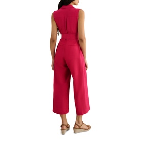 Model wearing Hobbs cherry pink sleeveless belted wide-leg culotte jumpsuit, styled with nude wedge sandals, rear view.
