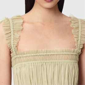 Close-up of sage green ruched dress with frilled shoulder straps and square neckline, showing textured pleated fabric detail
