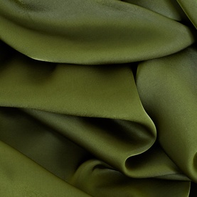Phase Eight green dress fabric close-up showing draped satin-finish material with soft folds and texture detail