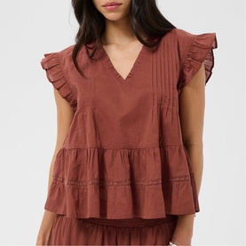 Model wearing Kaffe henna ruffle-sleeve V-neck tiered top with pintuck detailing, styled with matching tiered skirt.