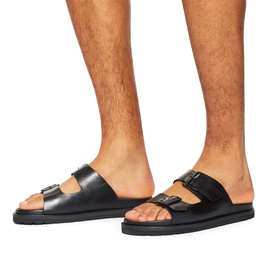 Model wearing KG by Kurt Geiger black leather double-strap buckle slides with black sole