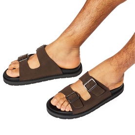 Model wearing KG by Kurt Geiger brown double-buckle strap sandals with chunky black sole