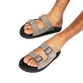 Model wearing KG by Kurt Geiger white suede double-buckle strap slides with black chunky sole