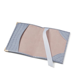 Aspinal of London Sky Blue croc-embossed passport cover, open view showing nude interior with elastic strap and gold-tone trim.
