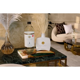 Rituals Savage Garden Refill Fragrance Sticks displayed with reed diffuser on marble coffee table in styled living room setting.