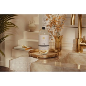 Rituals Royal Tea Refill Hand Wash large bottle on a gold tray, styled with dried flowers and gold tap in a neutral bathroom setting.