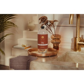 Rituals Wild Fig Refill Hand Wash large bottle displayed on a copper tray beside a gold tap and dried floral arrangement