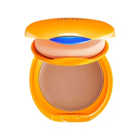 Shiseido Tanning Compact Foundation SPF10 in open orange compact with sponge applicator, revealing warm tan pressed powder