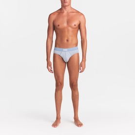 Model wearing Skims Briefs 3Pk in Nimbus Multi, light blue-grey brief with branded elastic waistband.