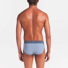 Model wearing Skims Briefs 3Pk in Nimbus Multi, rear view showing light blue brief with contrast waistband.