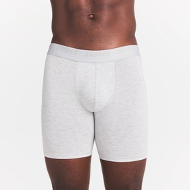 Model wearing Skims Boxers 3Pk in Iris Heather Multi, grey marl stretch fabric with elasticated logo waistband.