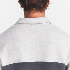 Model wearing Skims light heather grey lounge top, rear view showing colour-block design with darker grey lower panel and collar detail.