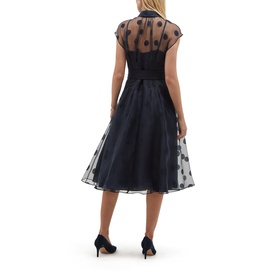 Model wearing Hobbs midnight navy sheer polka dot overlay midi dress with fitted bodice and full skirt, styled with black heels, back view
