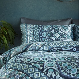 Vantona Kizzi Mandala Duvet Set in navy, featuring teal and blue paisley print on duvet and pillowcases, styled on a double bed