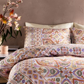 Vantona Kizzi Mandala Duvet Set in multi, featuring intricate paisley and floral print in lilac, rust and cream tones, styled on a double bed.