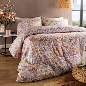 Vantona Kizzi Mandala Duvet Set in multi-coloured paisley print, styled on a double bed with two pillowcases, warm boho bedroom setting