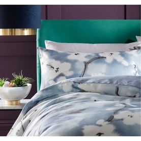 Vantona Osaka Duvet Set in multi, blue floral watercolour print, styled on bed with green velvet headboard