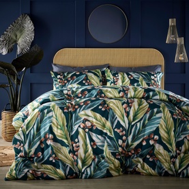 Vantona Twilight Leaves Duvet Set in multi, featuring bold tropical leaf and berry print in navy, green and coral tones, styled on a double bed.