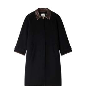 Sandro black longline coat with brown leather collar and concealed button placket, check lining visible at cuffs