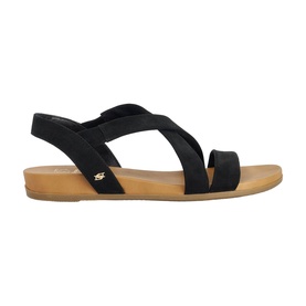 Dune black suede flat sandal with elasticated cross straps, toe loop, and tan rubber sole, gold logo detail