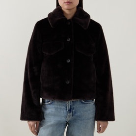 Model wearing Aligne brown faux fur cropped jacket with collar, chest pockets and button front, styled with light blue jeans.