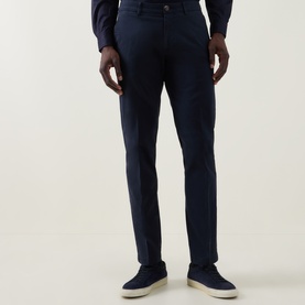 Model wearing Boggi Milano Garment-Dyed Trousers in navy, styled with a navy shirt and suede loafers, slim tailored fit