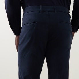 Model wearing Boggi Milano Garment-Dyed Trousers in navy, rear view showing stitched back pockets, styled with a navy shirt.