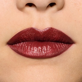 MAC Lustreglass Sheer-Shine Lipstick in Roan of Arc, a deep burgundy-red shade, shown on model's lips