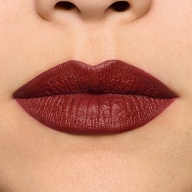 MAC MACximal Silky Matte Lipstick in UnNatural Redhead shown on lips, a deep burgundy-red matte shade