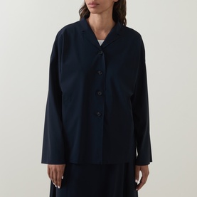 Model wearing Oska Single-Breasted Blazer in navy with notch lapel, button fastening, and dropped shoulders, styled with a navy skirt.