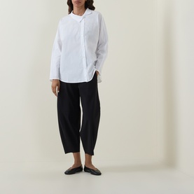 Model wearing Oska Straight Cropped Trousers in black, styled with a white oversized shirt and black flat shoes.