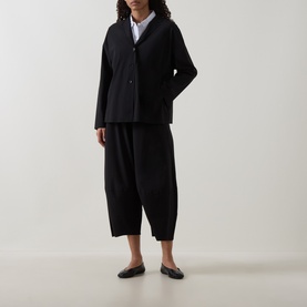 Model wearing Oska Wide Cropped Trousers in black, wide-leg silhouette, styled with a black blazer and white shirt, black loafers.