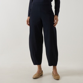 Model wearing Oska Straight Cropped Trousers in navy, styled with a navy knit top and tan loafers