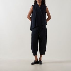 Model wearing Oska Wide Cropped Trousers in navy, wide-leg silhouette, styled with matching navy sleeveless top and black loafers.