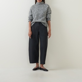 Model wearing Oska Wide Leg Cropped Trousers in black, wide-leg tapered silhouette with washed finish, styled with printed top and flat shoes.