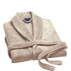 Pale taupe terry cloth bathrobe with shawl collar, tie waist, and embroidered logo detail, folded flat on white background.