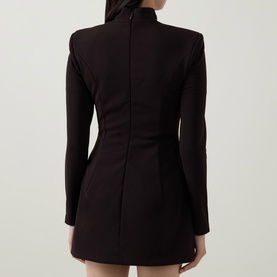 Model wearing Bardot dark chocolate mini dress, rear view showing structured shoulders, long sleeves, and fitted silhouette with back zip detail.