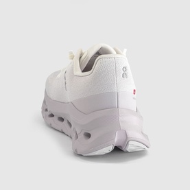 On Running trainer in Ether Ivory, rear three-quarter view showing chunky cloud sole unit and tonal upper with small red logo tab.