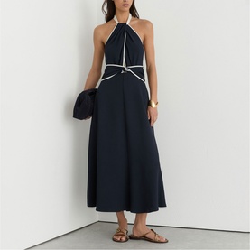 Model wearing Reiss blue halterneck midi dress with white trim detail, styled with tan sandals and carrying a dark clutch bag