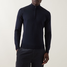 Model wearing John Smedley Tapton Extra Fine Knit Half-Zip Sweater in blue merino wool, styled with dark trousers.