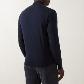 Model wearing John Smedley Tapton Extra Fine Knit Half-Zip Sweater in blue, back view, styled with grey trousers.