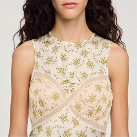 Model wearing Sandro Womens French Dress in olive and ecru floral print with lace panel detailing, sleeveless design
