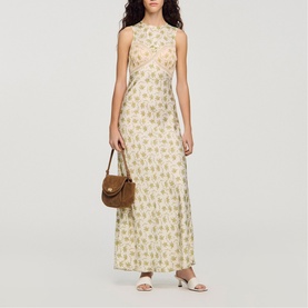 Model wearing Sandro Womens French Dress in olive and ecru floral print, styled with tan shoulder bag and white heeled mules.