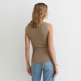 Model wearing Reiss dark neutral sleeveless ribbed tank top, styled with light blue jeans and gold bracelet, seen from behind.