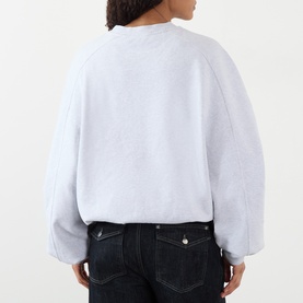 Model wearing Jacquemus Grey 950 cotton sweat top, rear view, styled with dark denim jeans.