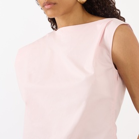 Model wearing Jacquemus light pink cotton sleeveless top with asymmetric draped neckline detail